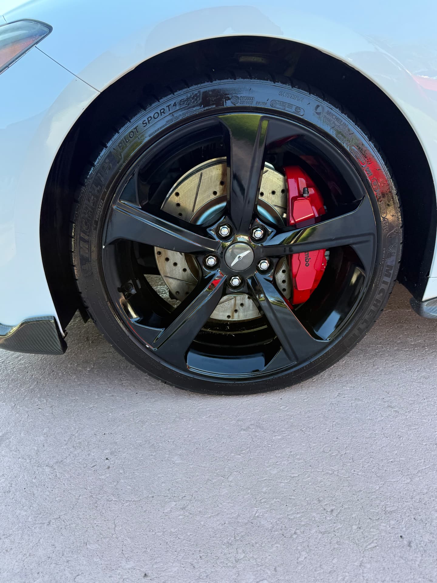 Genesis wheel and tire after detailed cleaning and dressing by Obsidian Auto Spa